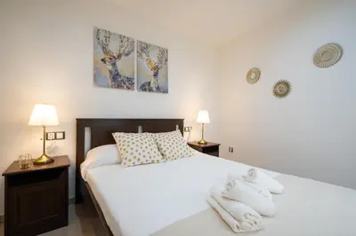 a bedroom with a bed with towels on it at CDZ - Cristóbal Colón in Cádiz