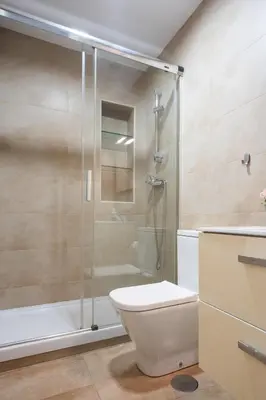 a bathroom with a toilet and a glass shower at CDZ - Cristóbal Colón in Cádiz