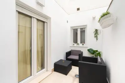 a living room with a window and a couch at CDZ - Cristóbal Colón in Cádiz