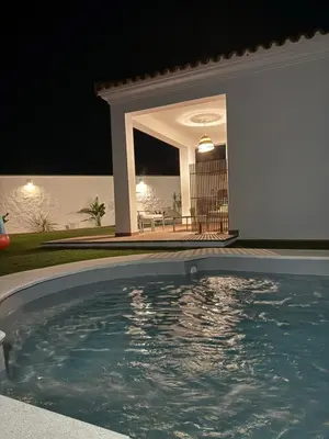 a swimming pool in front of a house at night at Casita de Mar in Conil de la Frontera