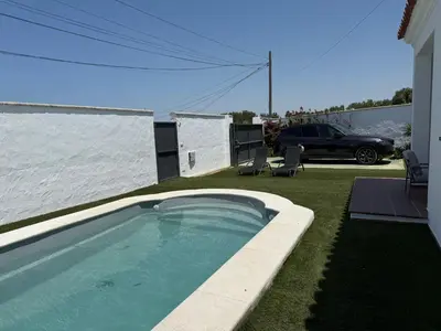 a swimming pool in the backyard of a house at Casita de Mar in Conil de la Frontera