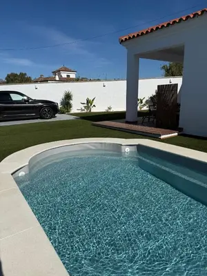 a swimming pool in the backyard of a house at Casita de Mar in Conil de la Frontera