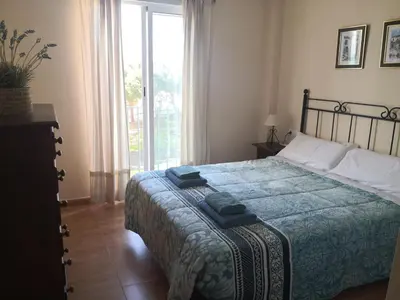 a bedroom with a bed and a large window at Casa Ensenada by 7Escalones in Rota