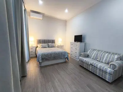 a bedroom with a bed and a couch at Casa San Juan 55 - Centro Sanlúcar in Sanlúcar de Barrameda