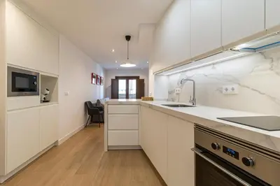 a kitchen with white cabinets and a sink at Allo Apartments Medina II Centro 1 Habitación in Jerez de la Frontera