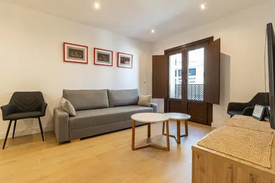 a living room with a couch and a table at Allo Apartments Medina II Centro 1 Habitación in Jerez de la Frontera