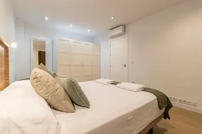 a bedroom with a large white bed with pillows at Allo Apartments Medina II Centro 1 Habitación in Jerez de la Frontera
