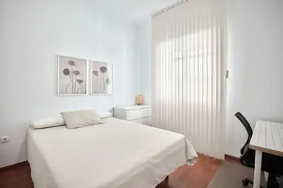 a white bedroom with a bed and a desk at Cuca Rooms by Cadiz Time in Cádiz