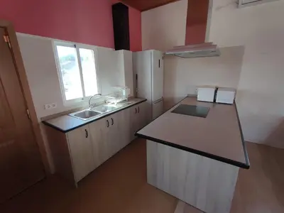 a small kitchen with a sink and a counter top at Apartamento Alhaja in El Puerto de Santa María