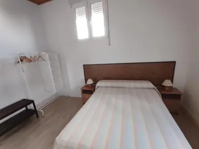 a bedroom with a bed and a window at Apartamento Alhaja in El Puerto de Santa María