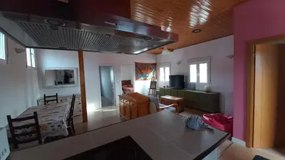 a living room with a table and a dining room at Apartamento Alhaja in El Puerto de Santa María