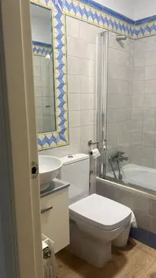 a bathroom with a toilet and a sink and a tub at FUENTEBRAVIA playa MRZ RENTALS in El Puerto de Santa María