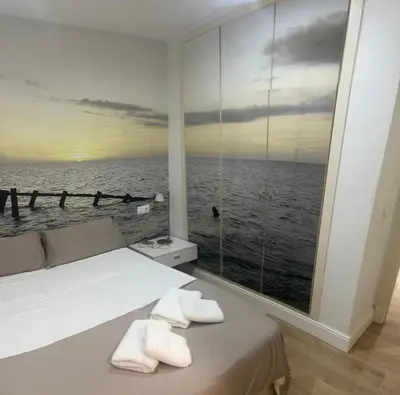 a bedroom with a view of the ocean at FUENTEBRAVIA playa MRZ RENTALS in El Puerto de Santa María