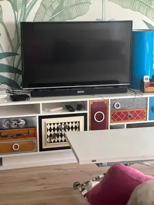 a tv sitting on top of a entertainment center at FUENTEBRAVIA playa MRZ RENTALS in El Puerto de Santa María