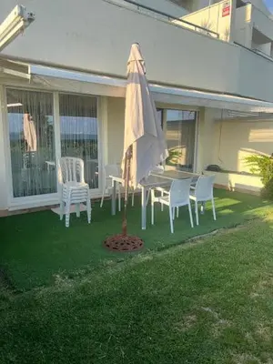 a patio with a table and chairs and an umbrella at FUENTEBRAVIA playa MRZ RENTALS in El Puerto de Santa María