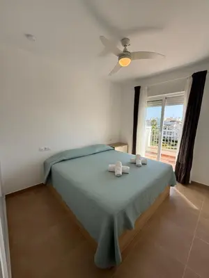 a bedroom with a bed with a ceiling fan at Ático Sabina free parking by staycare in Rota