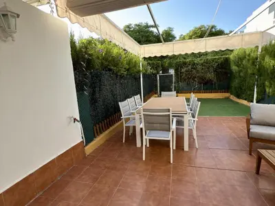 a patio with a table and chairs on it at Dúplex El Lago free parking by staycare in Rota
