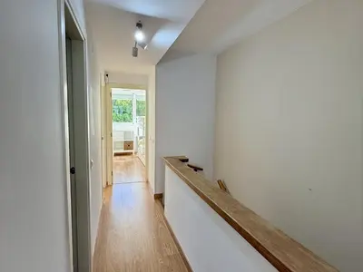 a hallway with white walls and a wooden floor at Dúplex El Lago free parking by staycare in Rota
