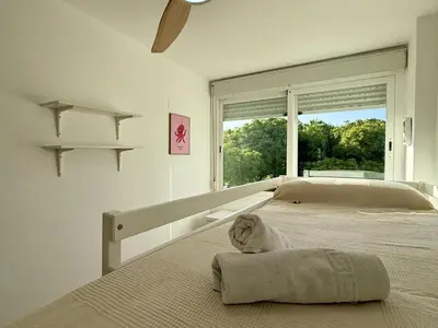 a bedroom with a bed with a large window at Dúplex El Lago free parking by staycare in Rota