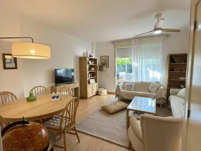 a living room with a table and a couch at Dúplex El Lago free parking by staycare in Rota