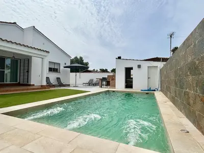 a swimming pool in the backyard of a house at Modern 3-Bedroom Villa with Private Pool & BBQ in Cádiz