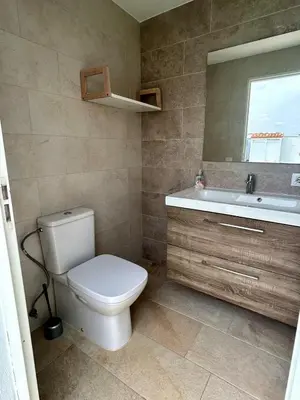 a bathroom with a toilet and a sink and a mirror at Modern 3-Bedroom Villa with Private Pool & BBQ in Cádiz