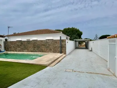 a house with a swimming pool in a yard at Modern 3-Bedroom Villa with Private Pool & BBQ in Cádiz
