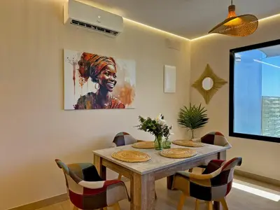 a dining room with a table and a painting on the wall at Casa Las Mironas II - Ole Solutions in El Puerto de Santa María
