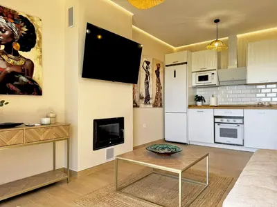 a living room with a couch and a table at Casa Las Mironas II - Ole Solutions in El Puerto de Santa María