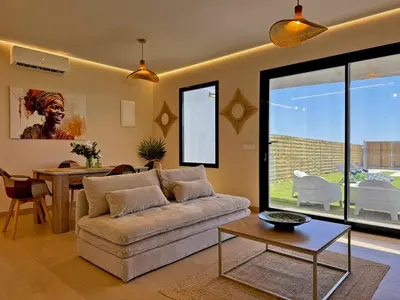 a living room with a couch and a table at Casa Las Mironas II - Ole Solutions in El Puerto de Santa María