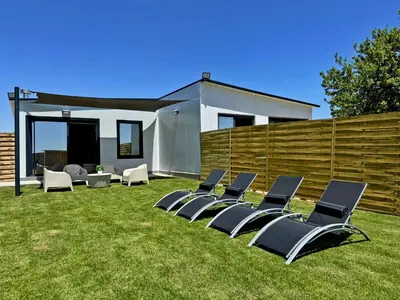 a group of chairs sitting on the grass at Casa Las Mironas II - Ole Solutions in El Puerto de Santa María