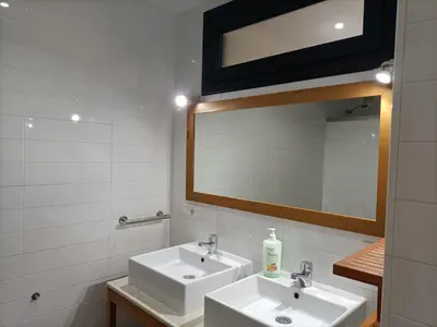 a bathroom with two sinks and a mirror at Góngora 2 in Chipiona
