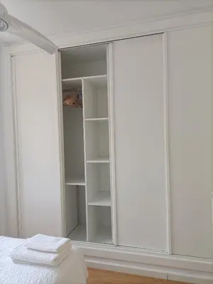 a bedroom with white wardrobes at Góngora 2 in Chipiona