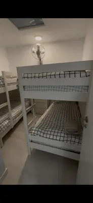 a white bunk bed in a room with a light at Pleamar Apartamento in El Puerto de Santa María