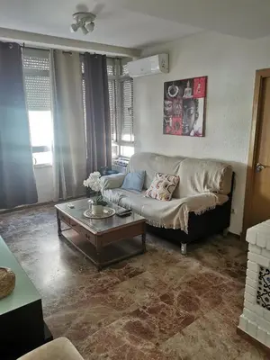 a living room with a couch and a coffee table at Se alquilan habitaciones in Jerez de la Frontera