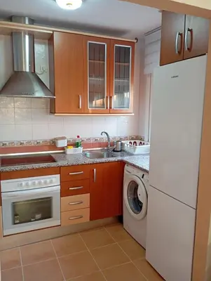 a kitchen with a washing machine and a washer at Villa León in Chipiona