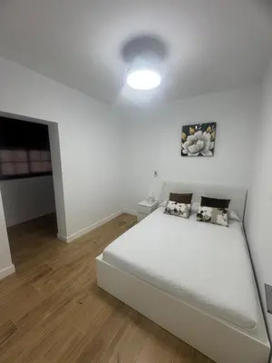 a bedroom with a large white bed in a room at Ático Safari in Sanlúcar de Barrameda