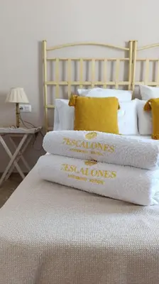 a stack of towels on top of a bed at Casa Tuca by 7Escalones in Rota