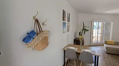 a living room with a table and a dining room at Casa Tuca by 7Escalones in Rota