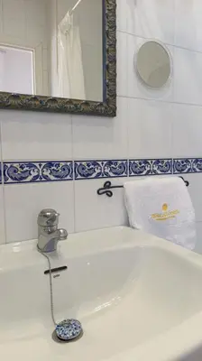a white bathroom with a sink and a mirror at Casa Tuca by 7Escalones in Rota