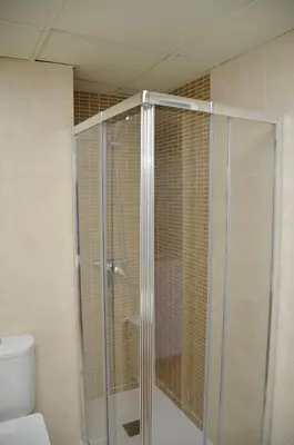 a glass shower in a bathroom with a toilet at El Rincón de la Artista in San Fernando