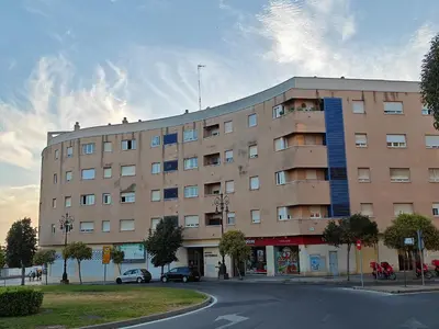 a large building on the corner of a street at El Rincón de la Artista in San Fernando