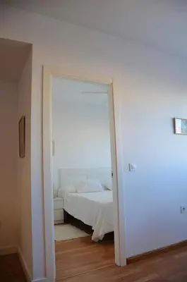 a bedroom with a bed and a large doorway at El Rincón de la Artista in San Fernando
