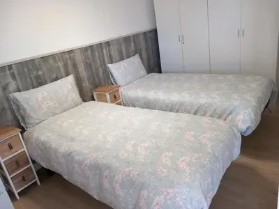 two beds sitting next to each other in a room at Countryside villa & private Covered Pool in Chiclana de la Frontera