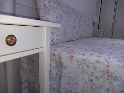 a bedroom with a bed with a floral bedspread at Countryside villa & private Covered Pool in Chiclana de la Frontera