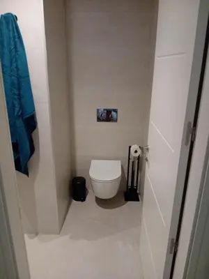 a small bathroom with a toilet and a blue towel at San juan 32 bajo E in Sanlúcar de Barrameda