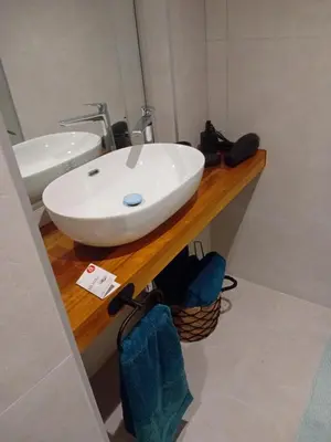 a bathroom with a white sink on a wooden counter at San juan 32 bajo E in Sanlúcar de Barrameda