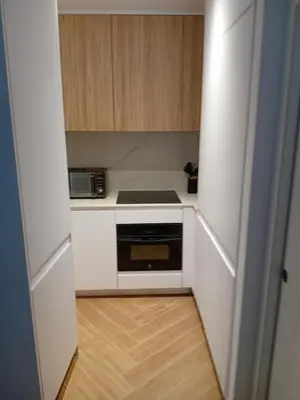 a small kitchen with a stove and a microwave at San juan 32 bajo E in Sanlúcar de Barrameda