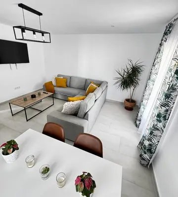 a living room with a couch and a table at Apartamento Muñoz Fornell 3 in Chiclana de la Frontera