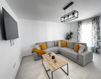 a living room with a couch and a table at Apartamento Muñoz Fornell 3 in Chiclana de la Frontera